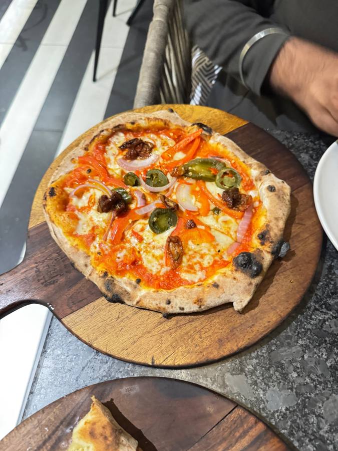 Pizza with jalapeños, onion and honey