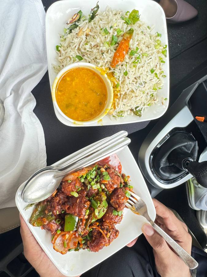Jeera rice with dal and gobi manchurian, eaten in a car