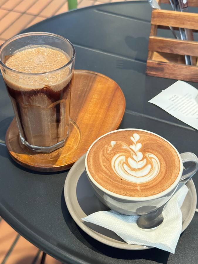 Iced coffee and a cappuccino with latte art