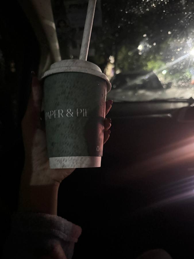 Paper and Pie coffee cup in the car at night