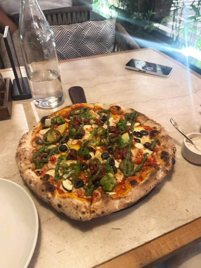 Pizza topped with green chillies and pesto
