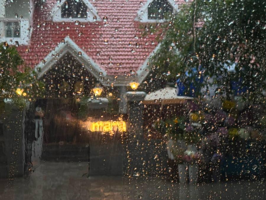 Rain on the window, looking out at Mara's red building