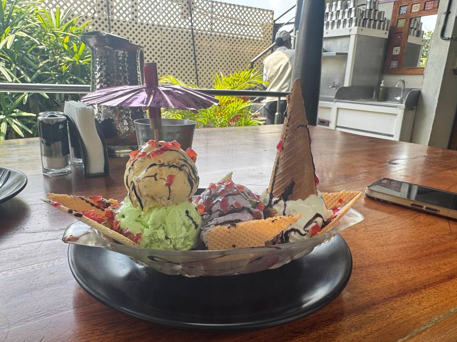 A giant ice cream sundae with cones and wafers